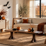 Modern Halloween-themed living room with cozy furniture and autumn decor.